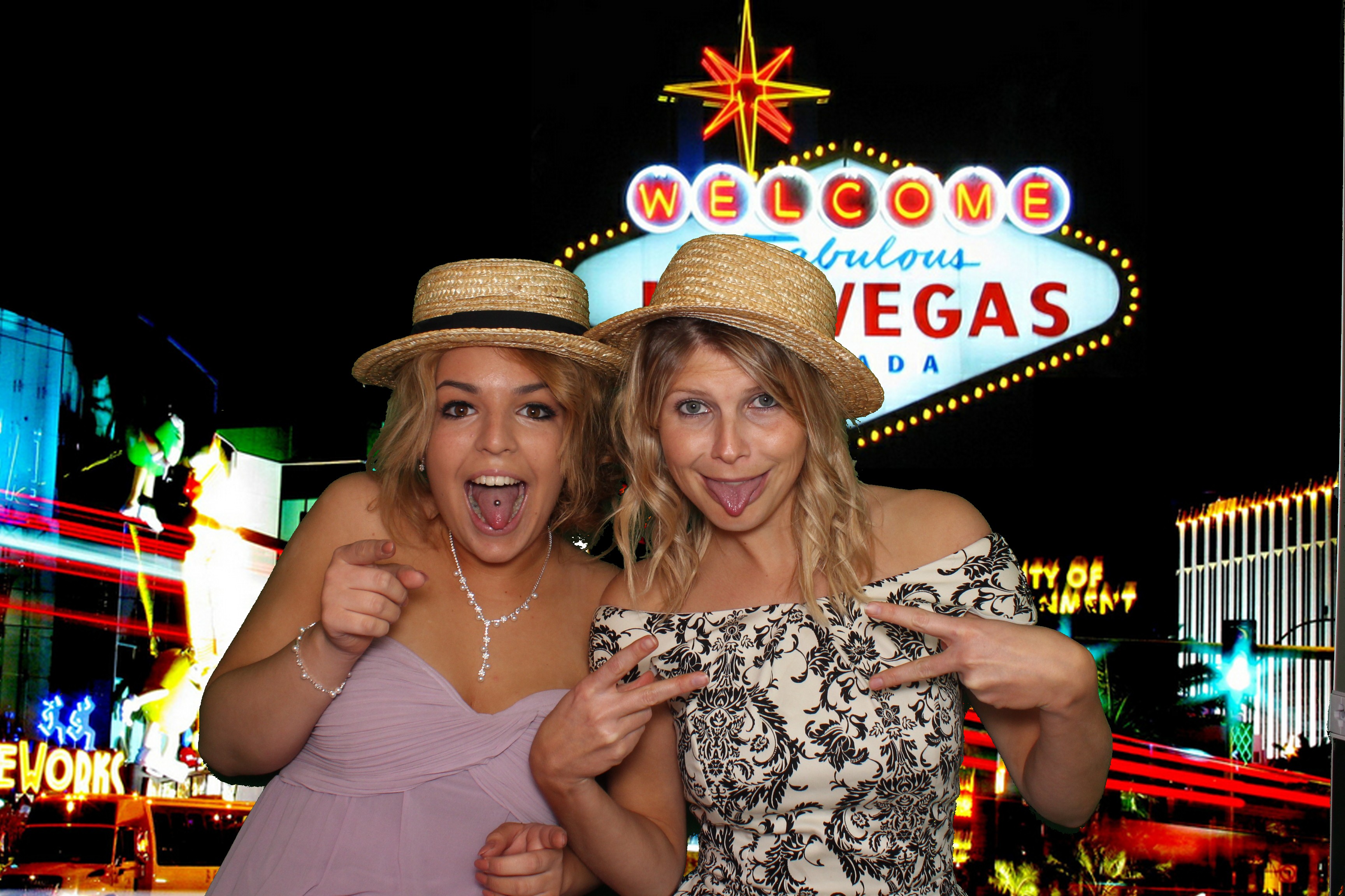 images shows two women in front of a greenscreen generated photo booth background